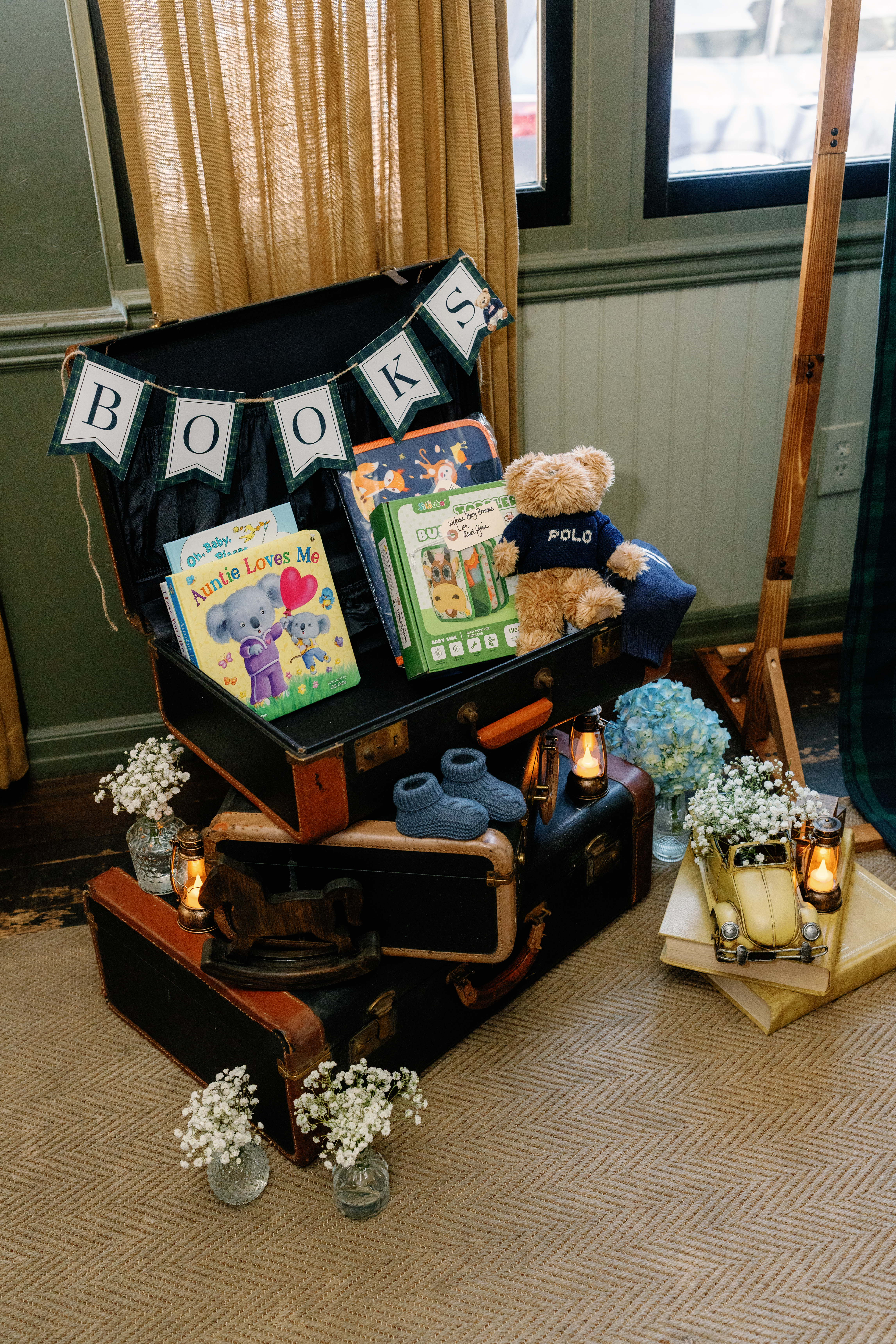 Vintage suitcase book station with Polo teddy bear and baby booties