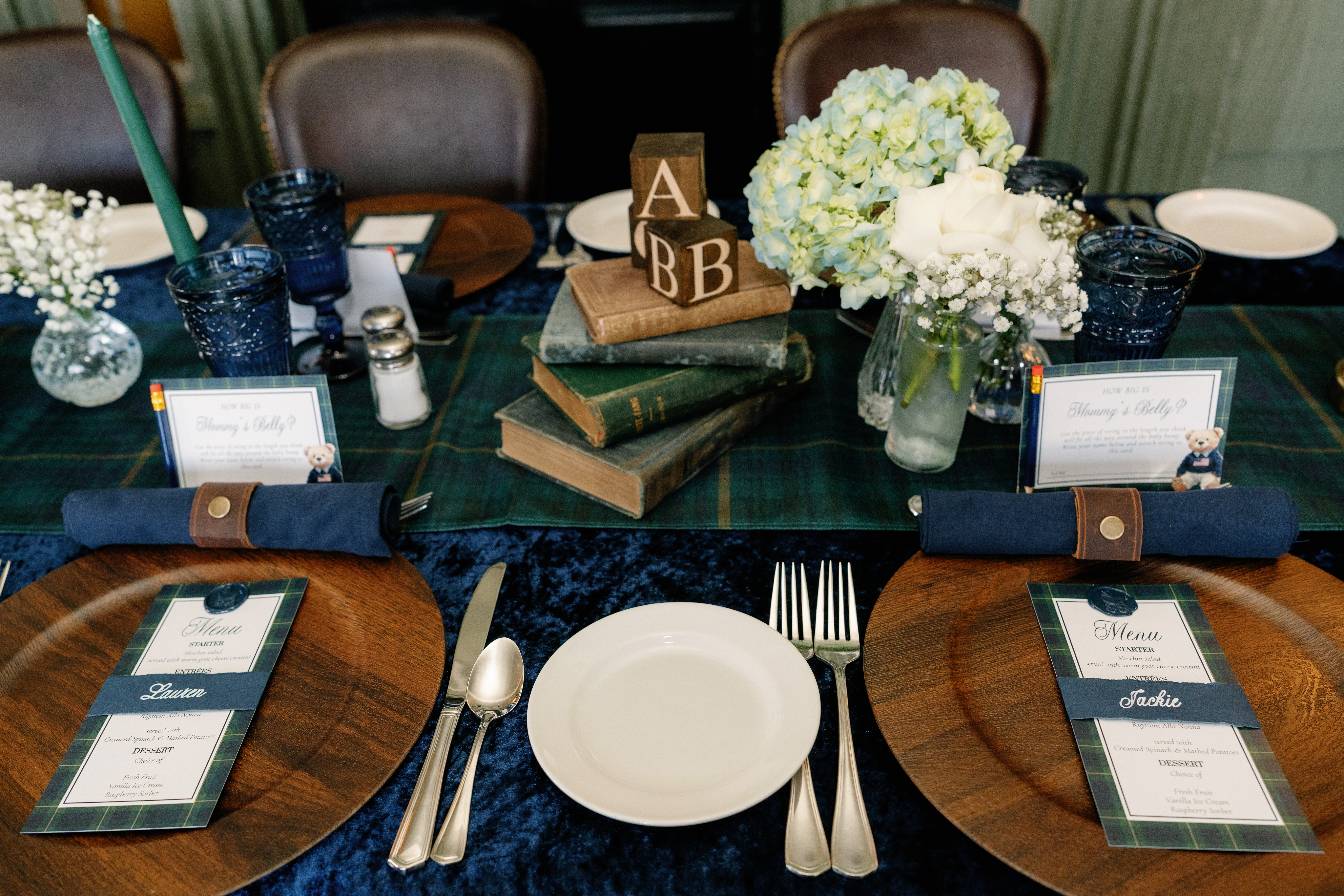 Baby shower place setting with wooden charger, plaid menu card, ABC block centerpiece, and personalized name card