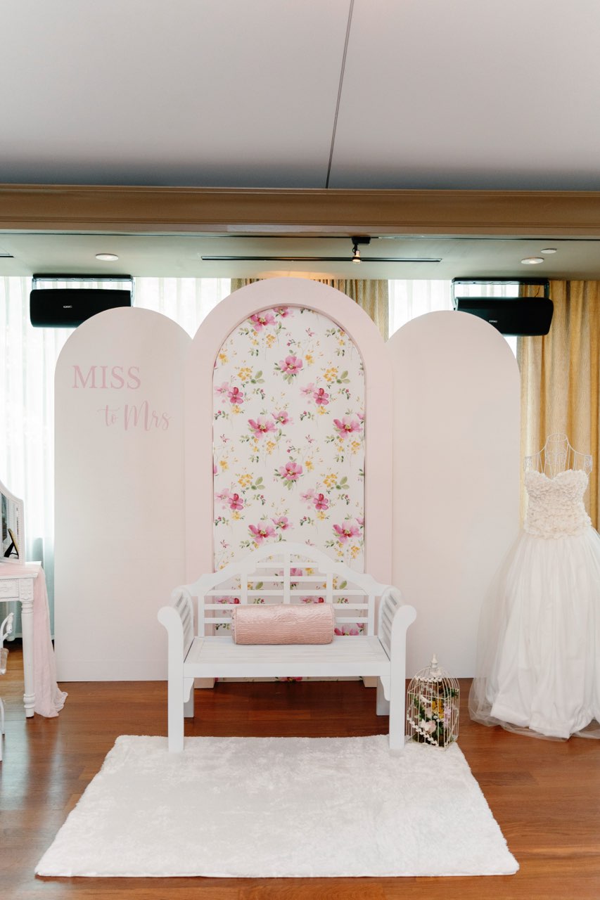 Miss to Mrs bridal shower floral arch backdrop with styled seating